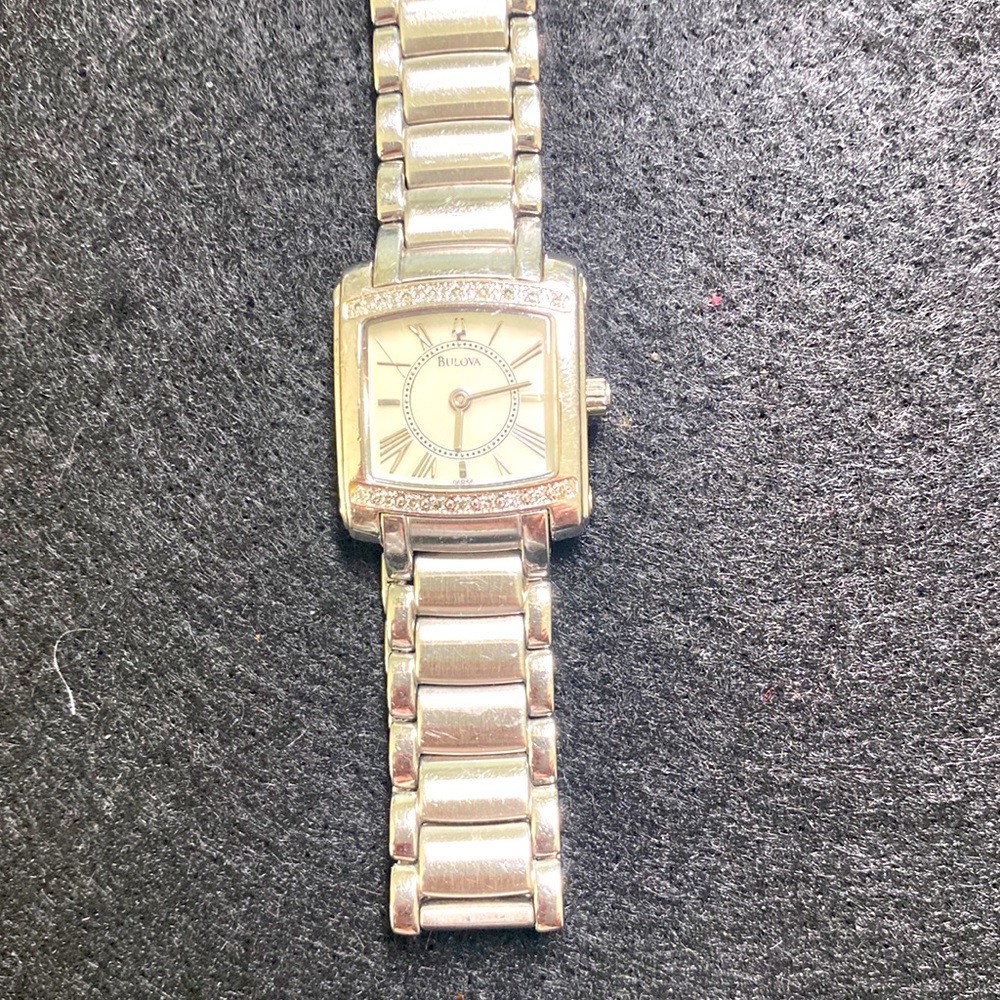 Bulova Woman's watch. Diamond chips around dial.